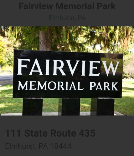 Black granite mausoleum crypt with bronze plaque reading “FAIRVIEW MEMORIAL PARK” on three square bases in a grassy area.