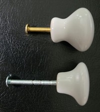 8 WHITE 3/4 INCH KNOBS  3 WHITE 1  1/8 KNOBS. ALL 1  1/4 INCH DIAMETER