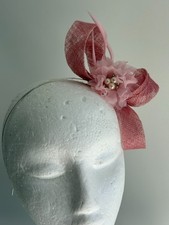 Light pink sinamay loop fascinator with feathers and flower on a headband 