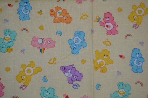 Cotton fabric, pale yellow Care Bears print, 44" x 32"