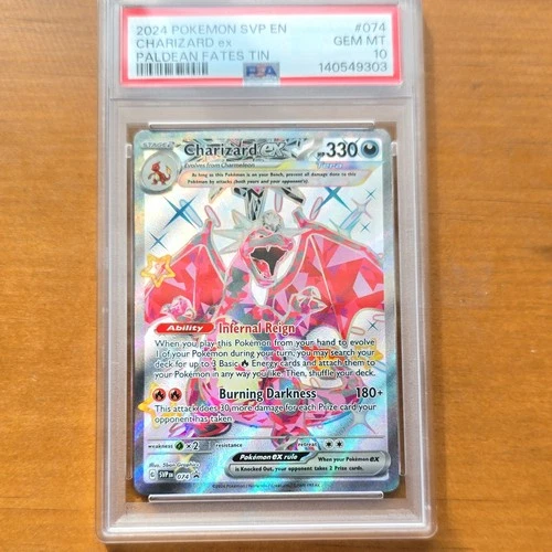The Pokémon Company 2024 Charizard ex SVP 074 Paldean Fates Tin Holo PSA 10