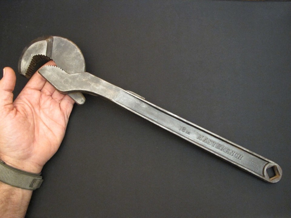 A massive 19-inch HELLER quick-adjust pipe wrench from the antique tool era — heavy, beautiful patina, and the kind of thing that stops people mid-conversation.