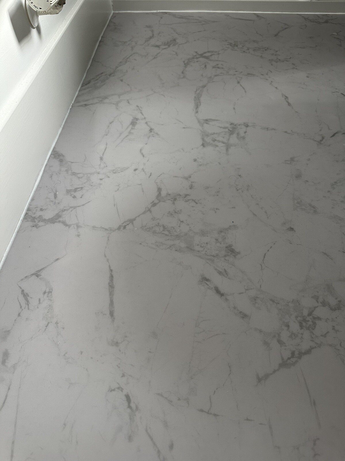 Forbo Eternal Material vinyl flooring roll remnant in White Marble