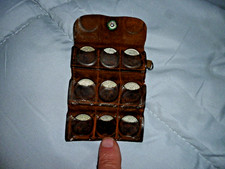 old sixpence coins in folding leather pouch