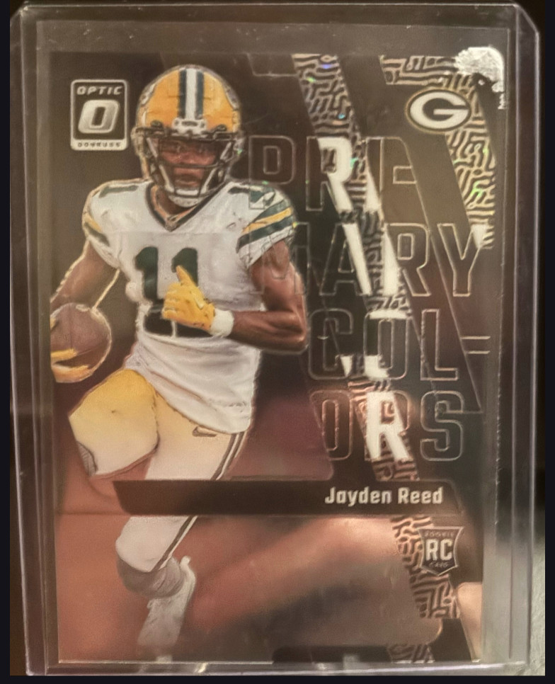 2023 Panini Donruss Optic - Primary Colors Jayden Reed #12 Purple Stars Prizm/25