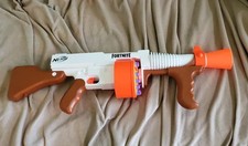 a fortnite nerf gun with a drum it is orange and white bullets not in clouded.