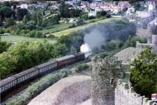 Photo 6x4 Steam train passes Conwy Castle Date is very approximate. c1990