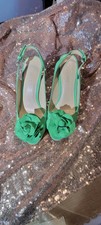 Women's Nine West green slingback, with a flower on toe, a 4 inch heel, size 6.5