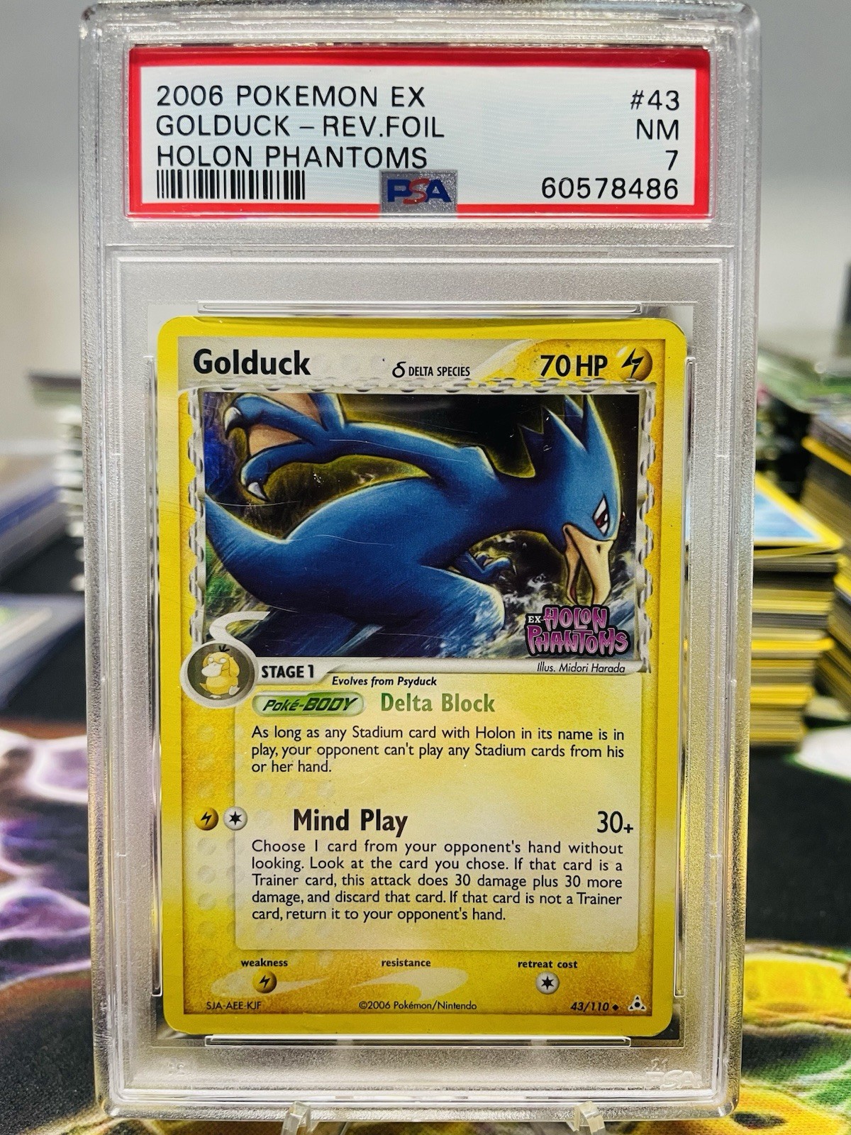 PSA 7 Golduck 43/110 2006 Holon Phantoms STAMPED Reverse Holo Pokemon Card