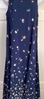 Navy blue midi dress with small white floral print, long sleeves, fitted waistline, and “E.D. Michaels” label on neckline.