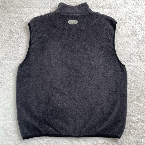 Dark gray Polartec fleece golf vest with high collar, front zipper, and small white logo on left chest.