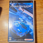 PSP NTSC-J Namco Ridge Racers 2 game case with blue sports car, Japanese text, and CERO A rating in protective sleeve.