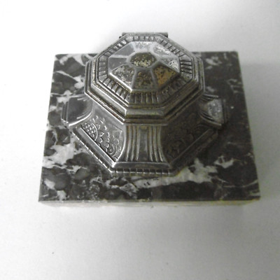 old inkwell in regular patina on marble