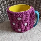 Hand Knitted plumb  coloured Mug Cosy With  daisy's