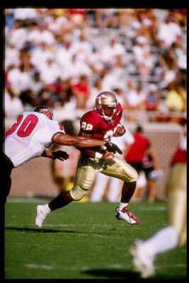 Davy Ford Florida State Seminoles tries to evade the grasp of - 1997 Old Photo