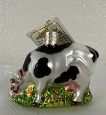 Merck Family's Old World Christmas ornament-black/white dairy cow in flowers