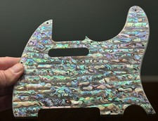 Premium handmade pickguard featuring real mot...