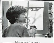 Press Photo A child looks out of the window at Home for Italian Children Center