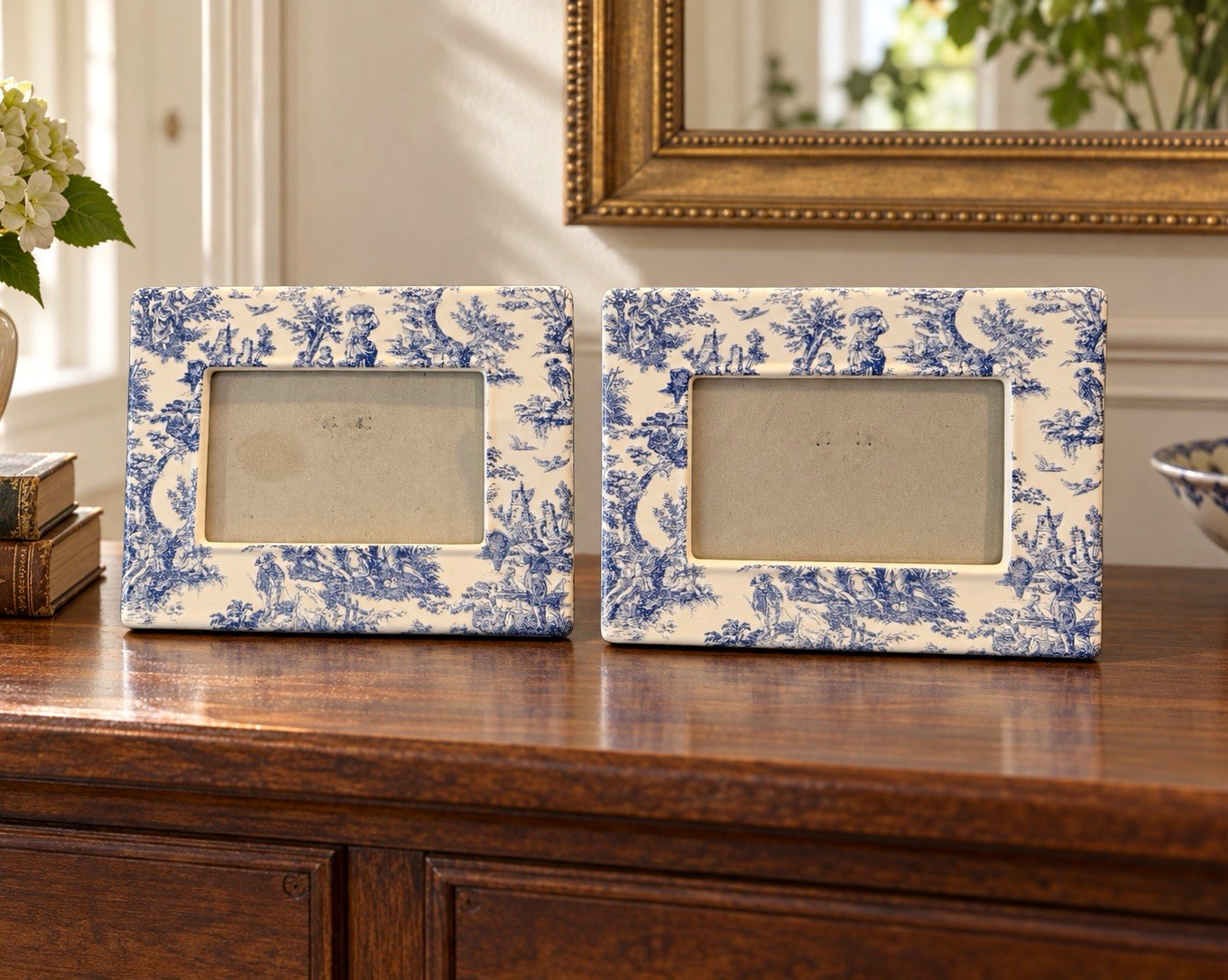 Two blue and white porcelain picture frames with toile de Jouy pastoral pattern.
