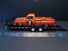 Mini GT Kaido House Chevrolet Silverado Dually Orange on open car trailer - 1:64