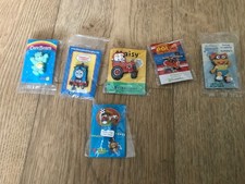 5 charity pin badges/1 sucker back,Care Bear,Daisy,Postman Pat,Thomas Tank,muppe