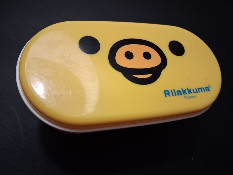 RILAKKUMA CHILDREN's TWO TIER BENTO BOX WITH CHOPSTICKS IN BOX YELLOW & BROWN.
