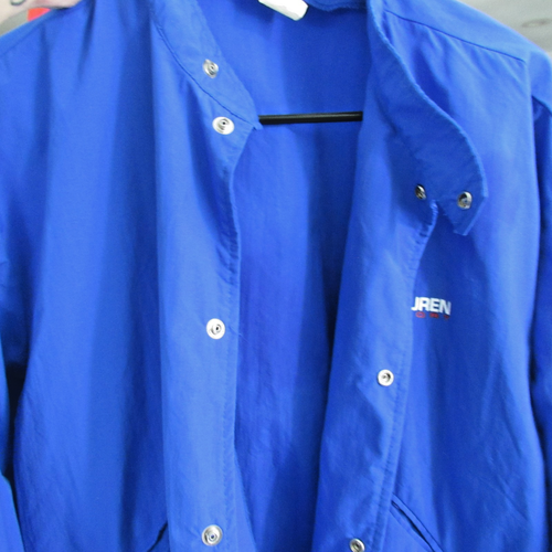 Blue vintage 90s Polo Sport Ralph Lauren jacket with white snap buttons, pointed collar, and small white “JREN” logo on chest.
