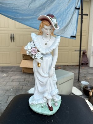 vintage porcelain figurine of a woman from the early 20th century
