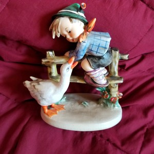 hummel boy on fence with goose