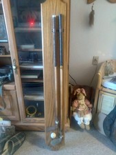 2 antique wood handled golf clubs on an amazing display. NICE