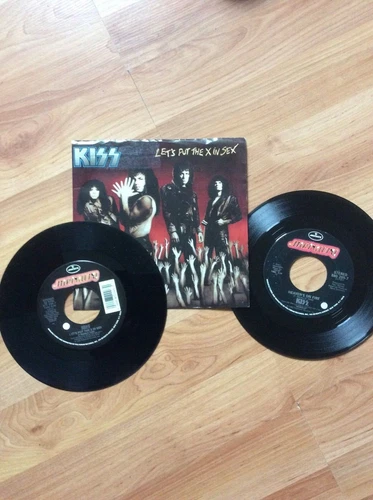 RECORDS VINYL TWO 45s  KISS 1988 LETS PUT X IN SEX / HEAVEN ON FIRE 1984