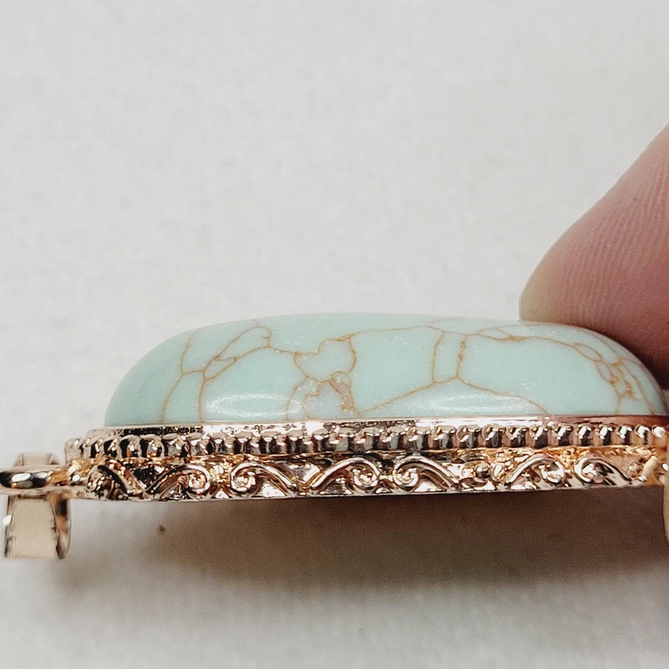 Colgante clásico ovalado de piedra azul claro ovalado tono oro rosa 1928 joyería de moda Foto 2 de 4