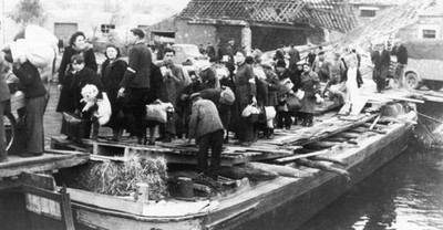 Civilians cross a makeshift bridge over Canal de Calais at a contr- Old Photo