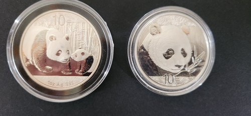 2 - 1 oz Chinese silver panda coins. 2011 and 2018 BU in capsule.