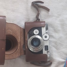 e Argus C-Four 35mm film camera with a leather case.