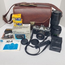 Minolta XG-A 35mm SLR Film Camera w/ 4 Lenses Case Flash Manuals New Batteries