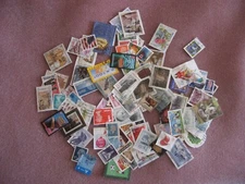 Stamps. 100 world mixed.No repeats.Paper backs off. Canada,Hungary,USA etc.Used