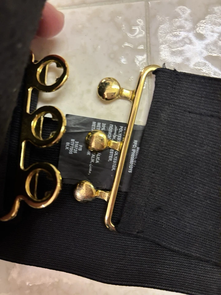 Cinturón Bebe ancho llamativo con pluma negro elástico talla S Foto 3 de 4