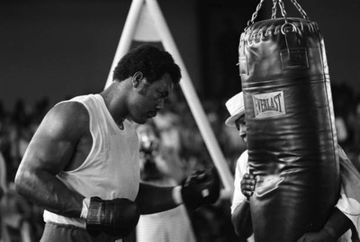 George Foreman hitting heavy bag while training before fight - 1974 Old Photo