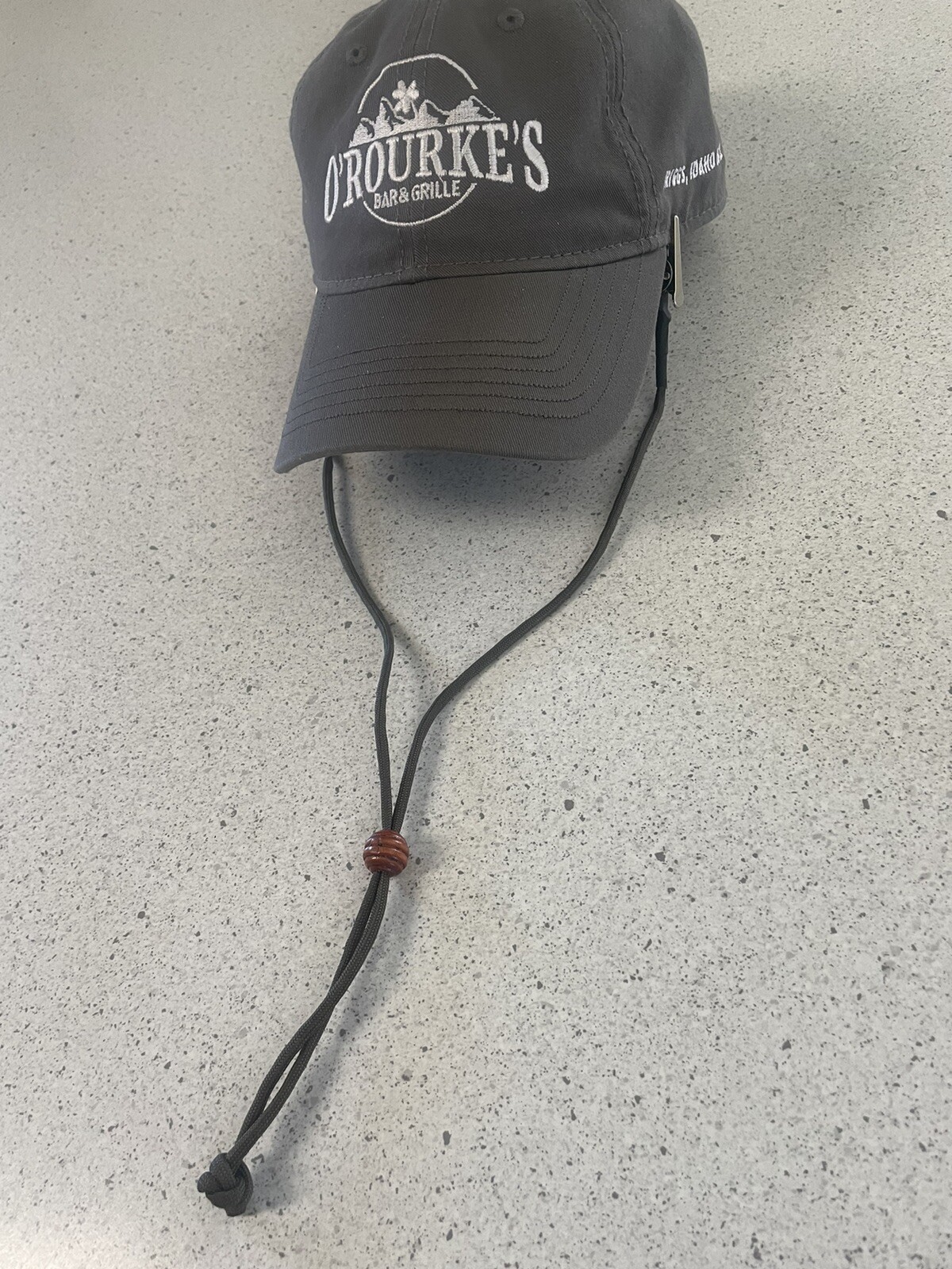 Clip-on olive green hat chin strap for secure fit and style-image