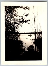 Vtg B&W Snapshot Man in Boat On Calm Lake Scenic Nature Landscape Trees 1950s