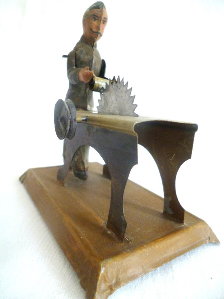 early 1900s man with a circular saw, a working model steam engine