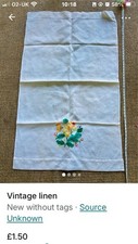 vintage hand-embroidered tea towel featuring floral motifs