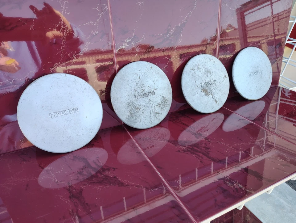 1990 - 1995 年马自达 323 Protege 626 车轮中心盖套装 (4) 原始设备制造商 # B457-7502 — 第 3/4 张图片