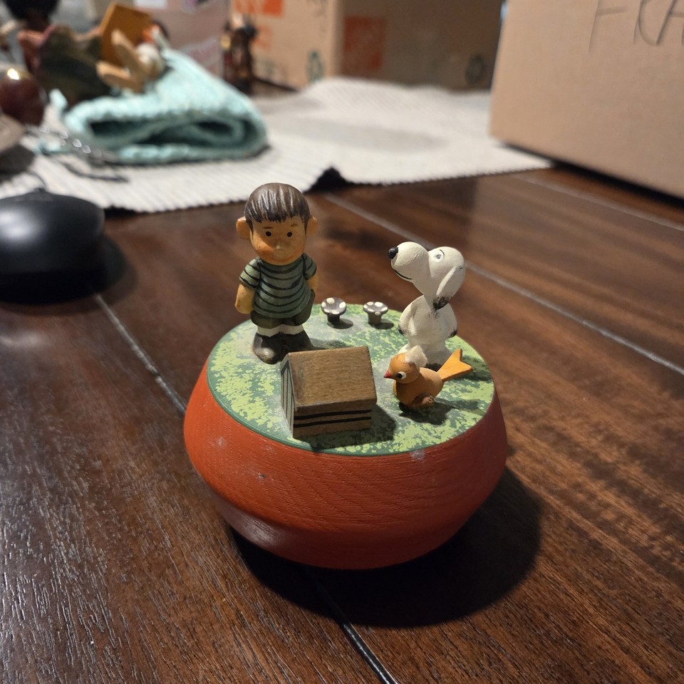 A 1972 Anri hand-carved Italian Peanuts music box with Linus, Snoopy, and Woodstock — Anri woodcarvings are legitimately collectible and this is a pop-culture holy grail.
