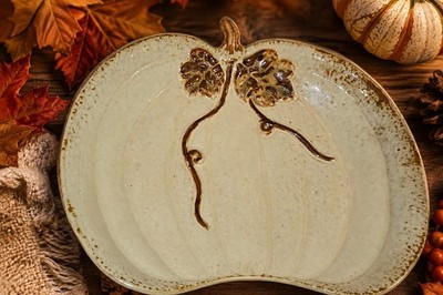 This is a Palm Tree Co. Ltd. beige glazed earthenware pumpkin serving plate...