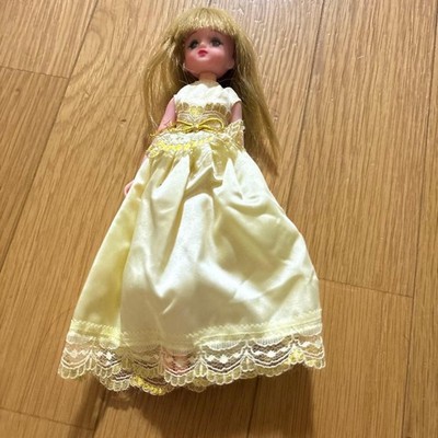 Licca-chan doll wearing a yellow dress, with one earring, no shoes