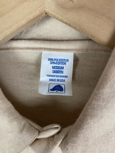 Tan vintage 80s Cresslers polo shirt, size medium, with white label showing fabric composition and “Made in U.S.A.”