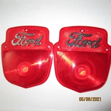 1953-60 Ford F-100 tail light lenses with chrome metal Ford script, new pair.