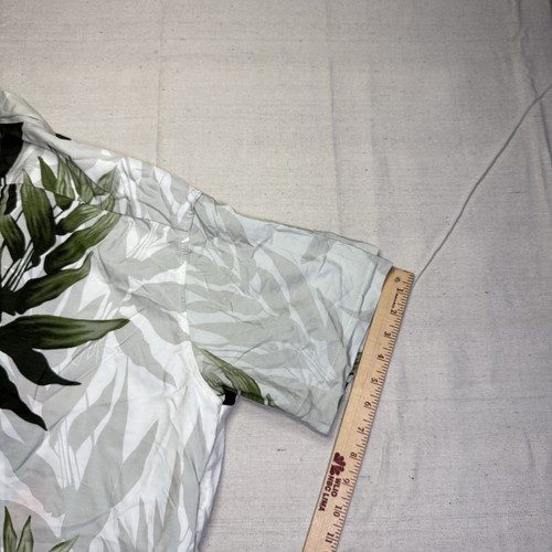 White vintage Wyland AFTCO Bluewater men’s Hawaiian shirt with green leaf print, shown beside a wooden ruler for scale.